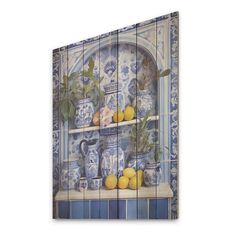 a blue and white tile wall with vases, lemons and oranges on it