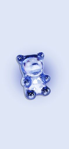 a blue glass bear sitting on top of a table