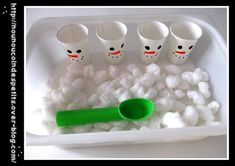 there are five cups and spoons in the tray with cotton balls on it that have been made into marshmallows