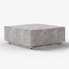 a gray marble coffee table with metal legs and an open drawer on the top that is closed