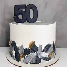 a 50th birthday cake with the number fifty on it's top and frosting