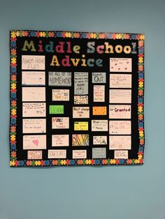 a bulletin board with writing on it and colorful papers attached to the back of it