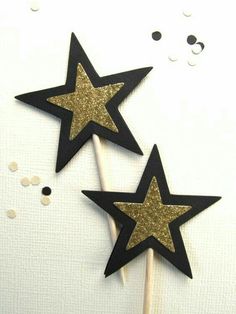 two black and gold stars on a stick