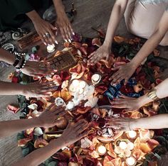 a group of people sitting around a table with candles on it