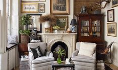 a living room filled with lots of furniture and pictures on the wall above it's fireplace