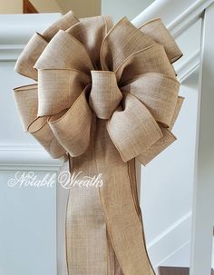 a close up of a large bow on a stair case in a house or home