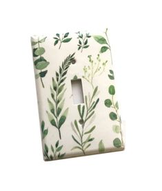 a light switch cover with green leaves on it