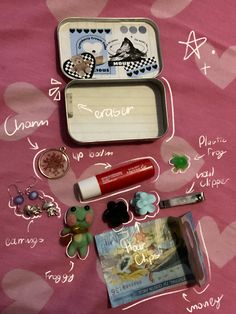 the contents of a school lunch box laid out on a pink tablecloth with hearts