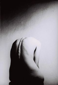 a black and white photo of a woman's back