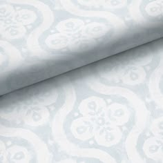 a blue and white wallpaper with an ornate design on it's surface,