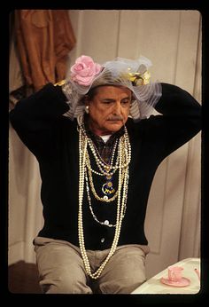 an old woman with pearls and flowers on her head