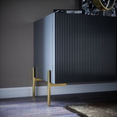 a room with a large radiator and a wooden object on the floor next to it