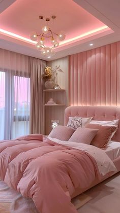 a bedroom with pink bedding and pillows on the floor, along with a chandelier