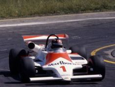 a man driving a racing car on a race track