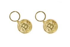 two gold bit coin keychains on a white background