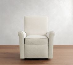 a white recliner chair sitting on top of a hard wood floor next to a wall