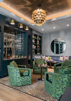 a living room filled with lots of furniture and a round mirror above the couches