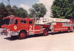 a red fire truck parked in a parking lot