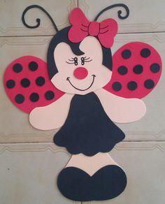 a paper cut out of a ladybug with a bow on it's head