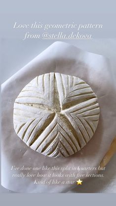 a piece of bread sitting on top of a white napkin next to a wooden spoon