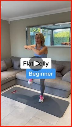 a woman is standing on a yoga mat in front of a couch with the words flat belly beginner