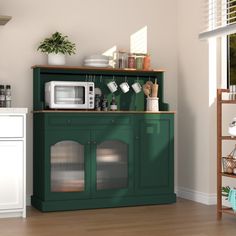 a kitchen with green cabinets and white appliances