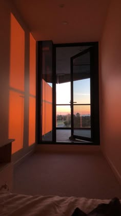 an empty bedroom with the sun shining through the window