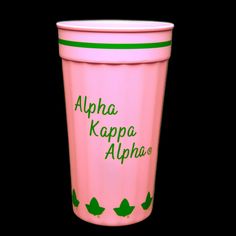 a pink cup with green leaves on the side and words written in arabic, aloha kappa aloha