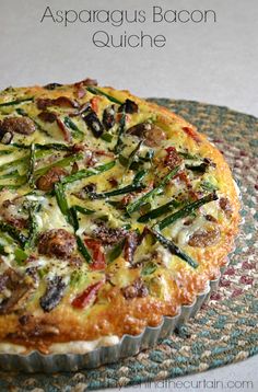 an asparagus bacon quiche on a blue and green plate with text overlay