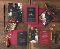 the wedding stationery is laid out on top of each other, including red and black cards