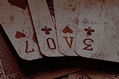 four playing cards with the word love written on them