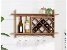 a wooden shelf with wine bottles and glasses on it