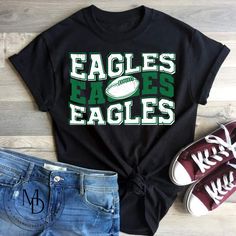 an eagles t - shirt, jeans and sneakers