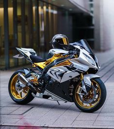 a white and gold motorcycle parked on the street