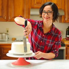 a woman cutting a cake with a knife