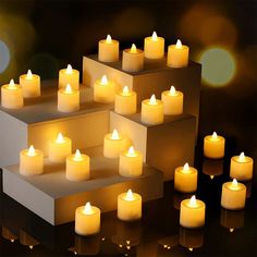 several rows of lit candles sitting on top of each other