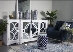 a living room with blue and white decor on the walls, furniture and rugs