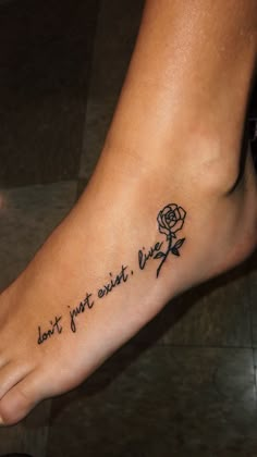 a foot with a rose tattoo that says don't just sit next to me