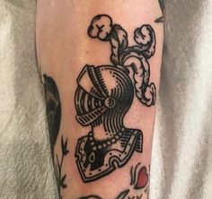 a man with a tattoo on his leg has a black and white image of a machine