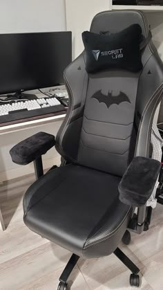 an office chair with a batman pillow on it