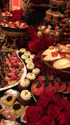 a table topped with lots of different types of cakes and cupcakes next to each other