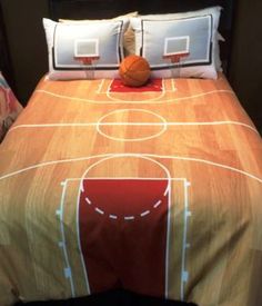 a bed with a basketball on it and two pillows