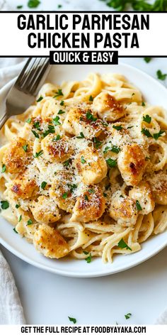 garlic parmesan chicken pasta on a white plate with a fork and garnish