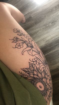 a woman's arm with flowers on it