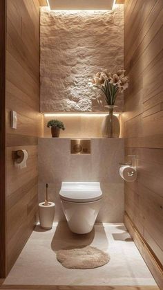 a modern bathroom with stone walls and wood paneling on the ceiling, along with a white toilet