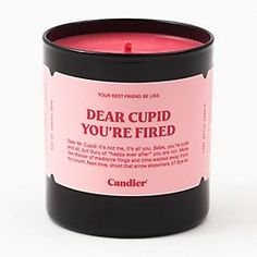 a candle that says dear cupid you're fired in front of a white background