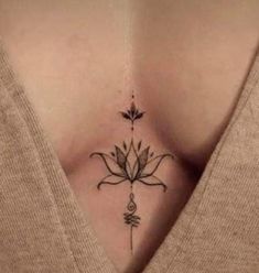 a woman's stomach with a flower tattoo on her chest and an arrow in the middle