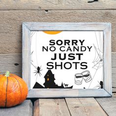 there is a sign that says sorry no candy just shots next to two pumpkins