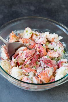 a glass bowl filled with shrimp and potato salad