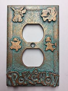 an old switch plate with pokemon pictures on it's front and back covers in gold